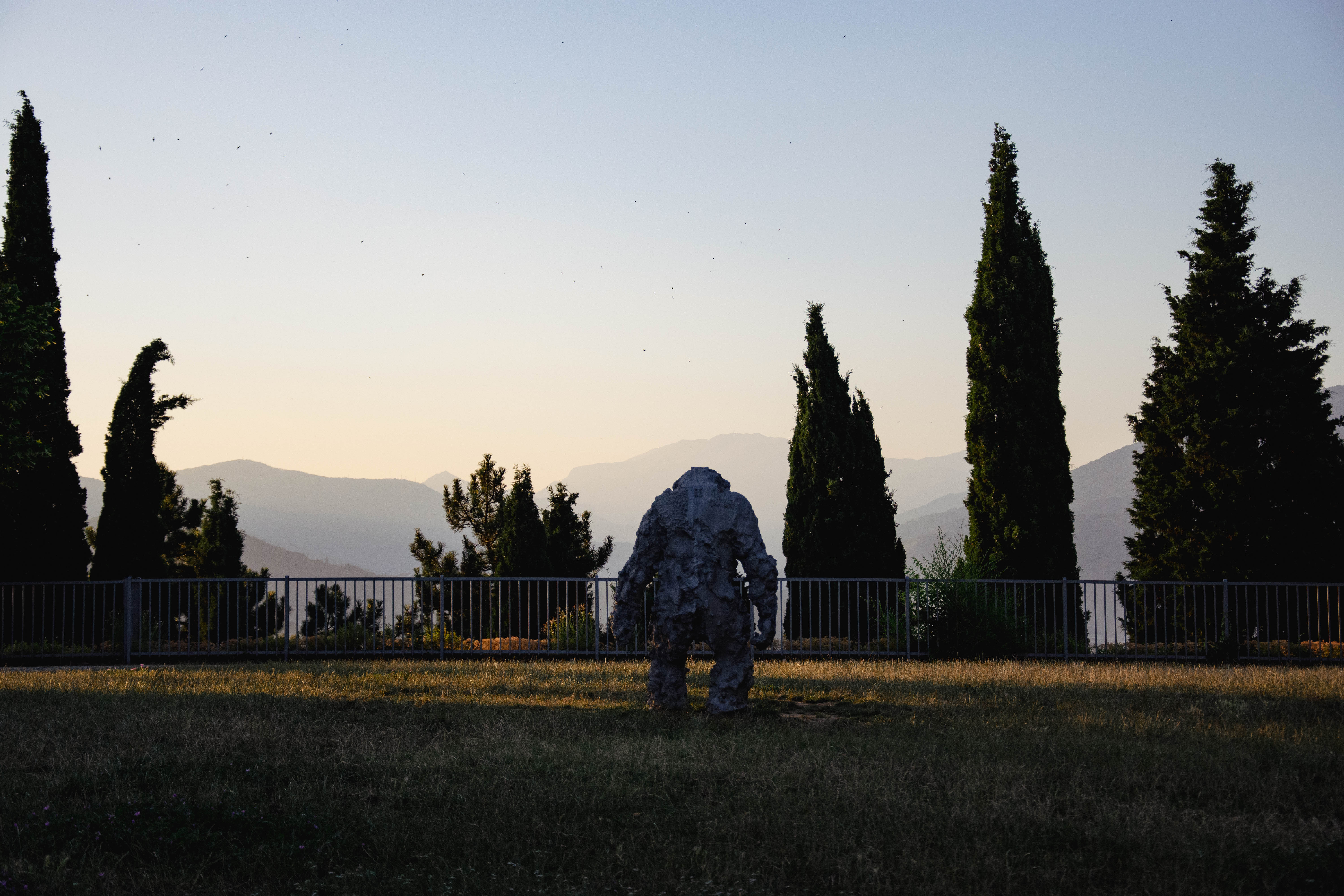 The statue of a monkey looking at the horizon at dusk